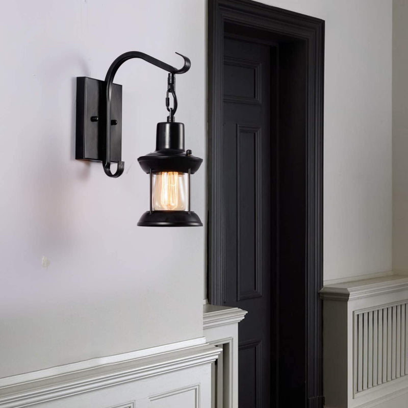 Etra industrial wall lamp installed and lit beside a doorway