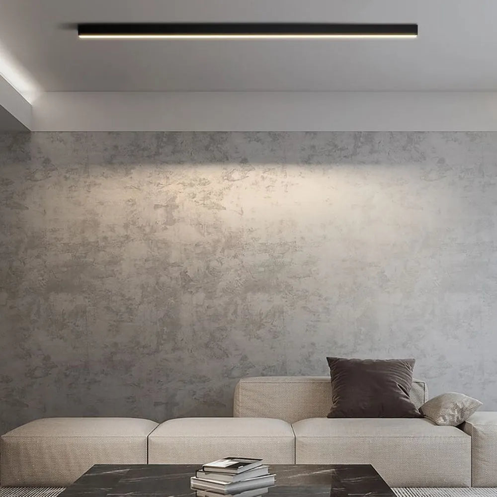 Solin linear black light installed and lit above a sofa