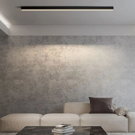 Solin linear black light installed and lit above a sofa