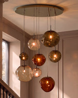 Orla 8-Bulb Mocha Caramel Glass Pendant Light above dining table