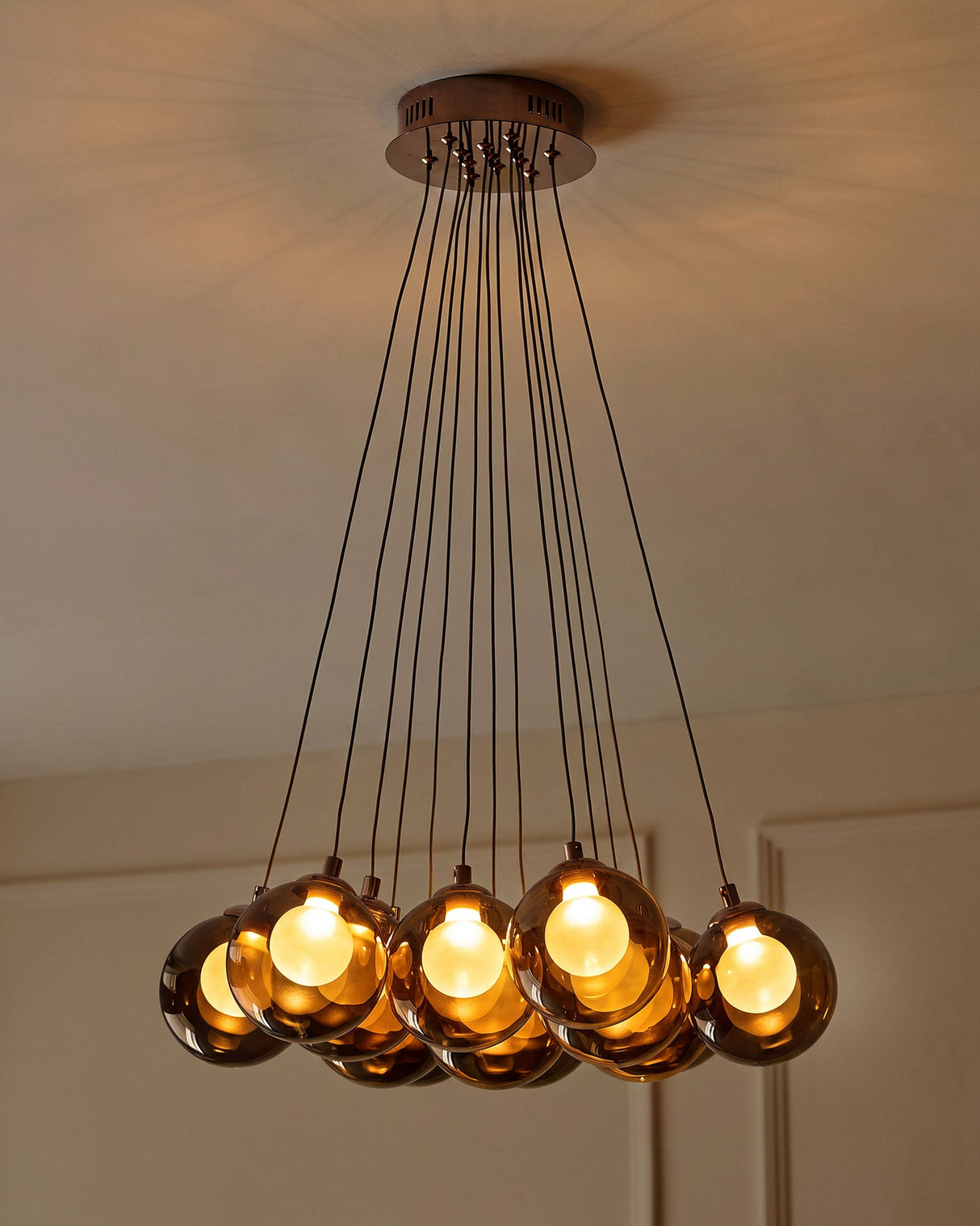 Riley Olive Green Glass Cluster Pendant Light lit above stairwell