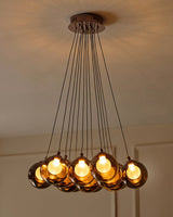 Riley Olive Green Glass Cluster Pendant Light lit above stairwell