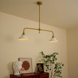 Zya vintage pendant light installed and lit above a sideboard