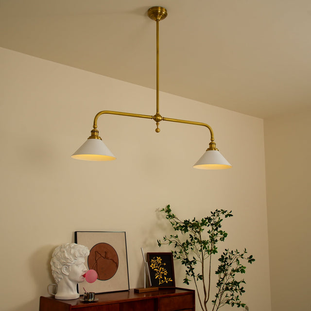 Zya vintage pendant light installed and lit above a sideboard